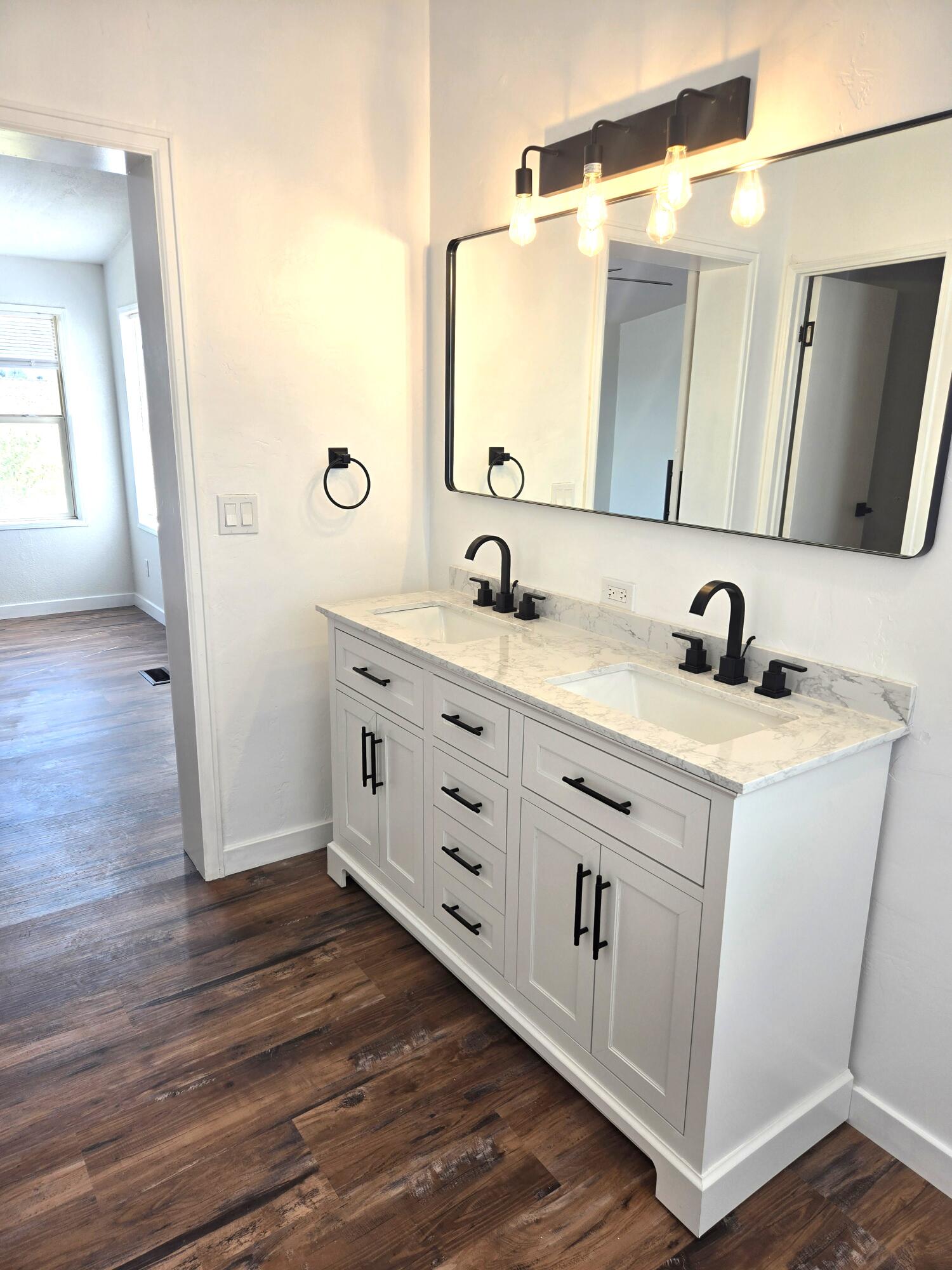 268 County Road Norwood, CO 81423 - Photo 23 of 28 a bathroom with a double vanity sink and mirror