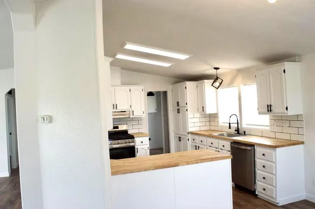a kitchen with a sink stove and refrigerator