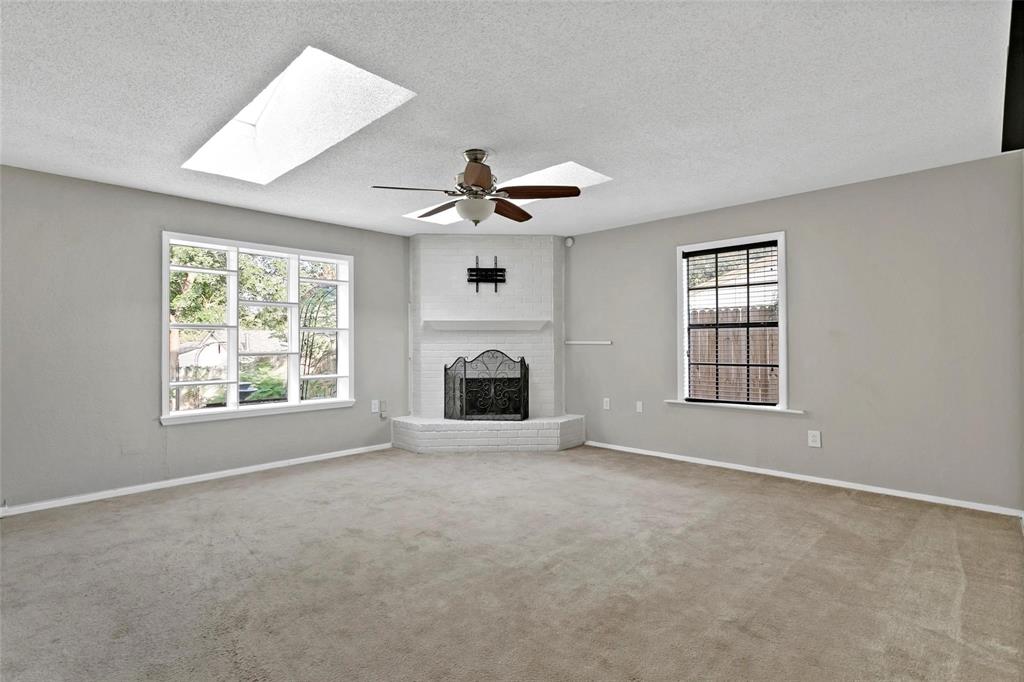 6104 Kelly Elliott Road Arlington, TX 76001 - Photo 20 of 25 an empty room with ceiling fan and windows