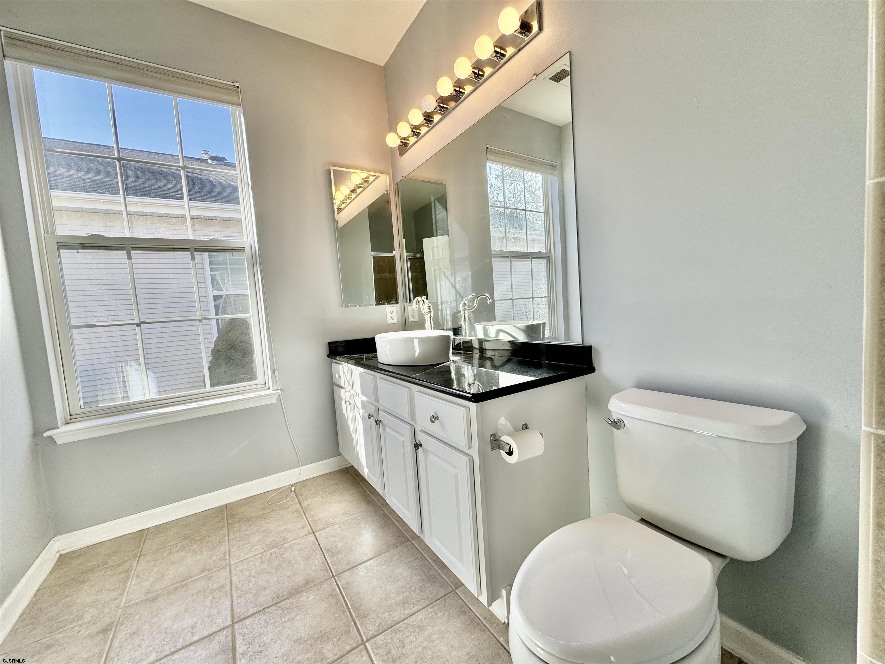 30 Wordsworth Street Galloway Township, NJ 08205 - Photo 23 of 46 a bathroom with a granite countertop toilet a sink and a mirror