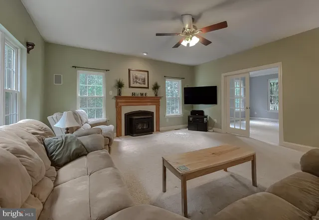 a kitchen with kitchen island granite countertop stainless steel appliances and view living room