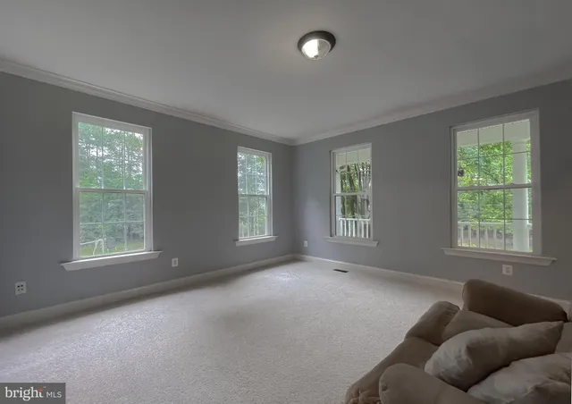 a view of a dining room with furniture and window