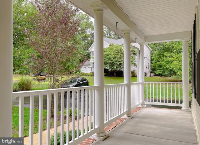 a view of a city from a balcony with wooden floor