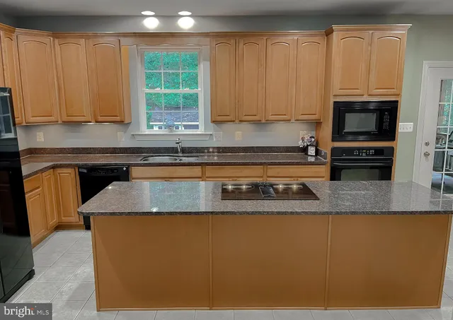 a bathroom with a sink a light fixture and a mirror