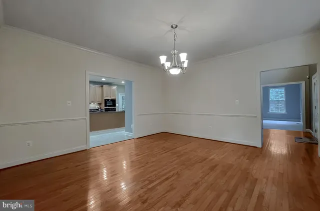 a spacious bedroom with a bed and a ceiling fan