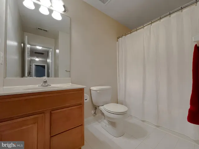 a bathroom with a tub a sink and a large mirror