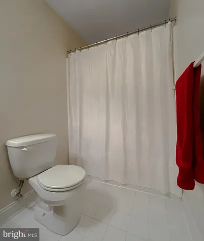 a room with granite countertop a refrigerator and a stove top oven