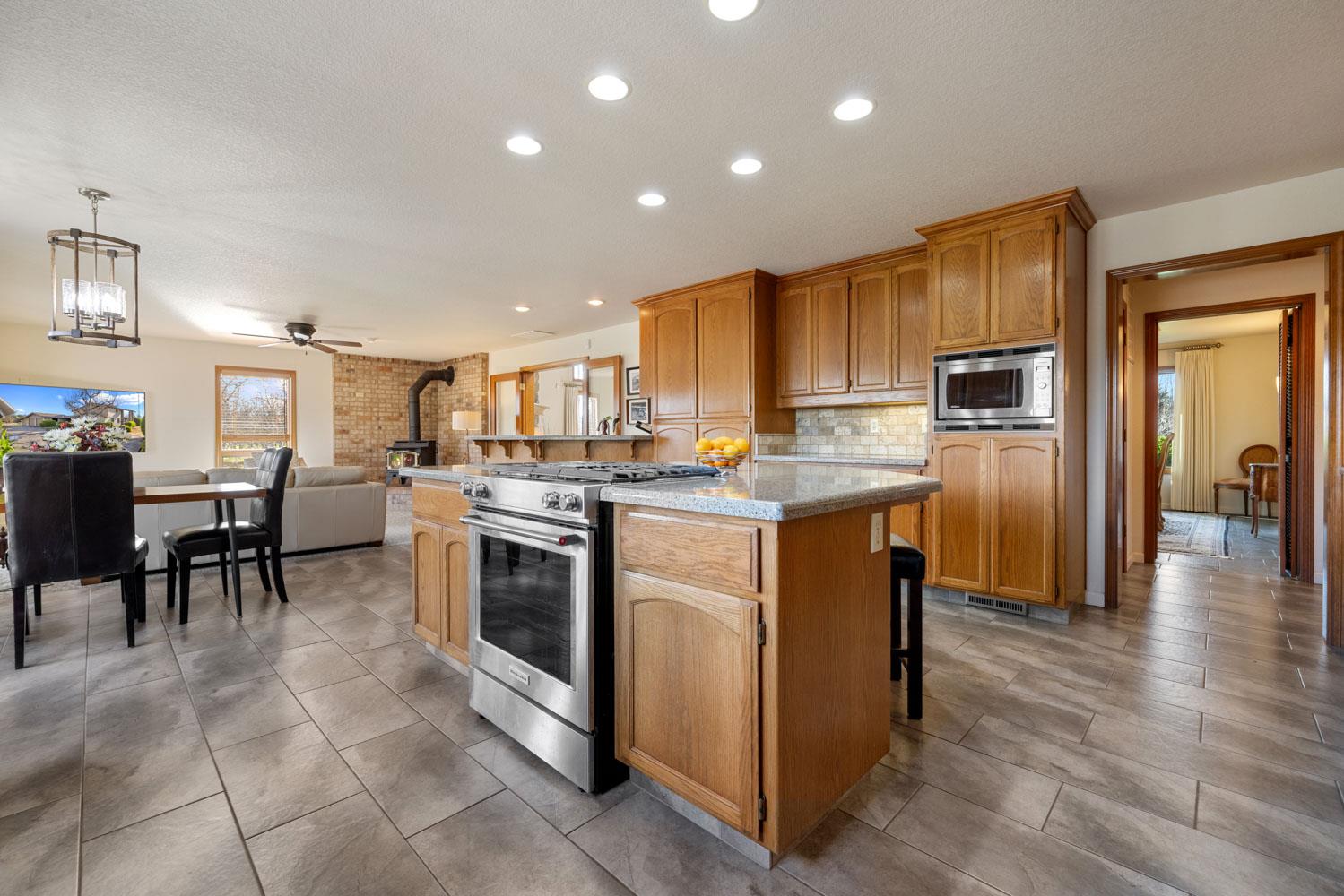 19909 Comstock Road Linden, CA 95236 - Photo 11 of 51 a kitchen with a refrigerator stove microwave and cabinets