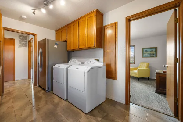 a view of a hallway with utility room and washer