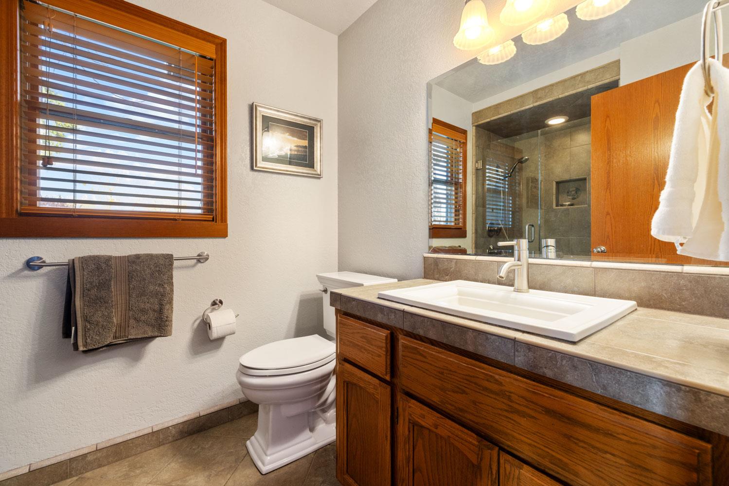 19909 Comstock Road Linden, CA 95236 - Photo 16 of 51 a bathroom with a sink a toilet and a mirror