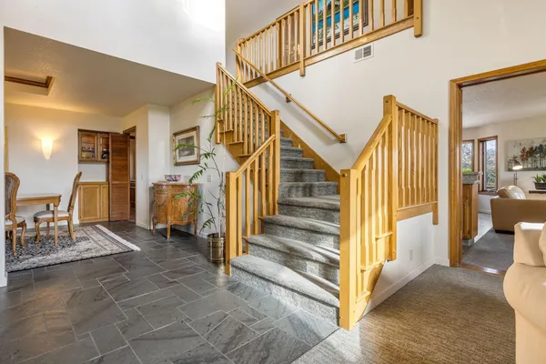 a view of a livingroom with furniture and stairs