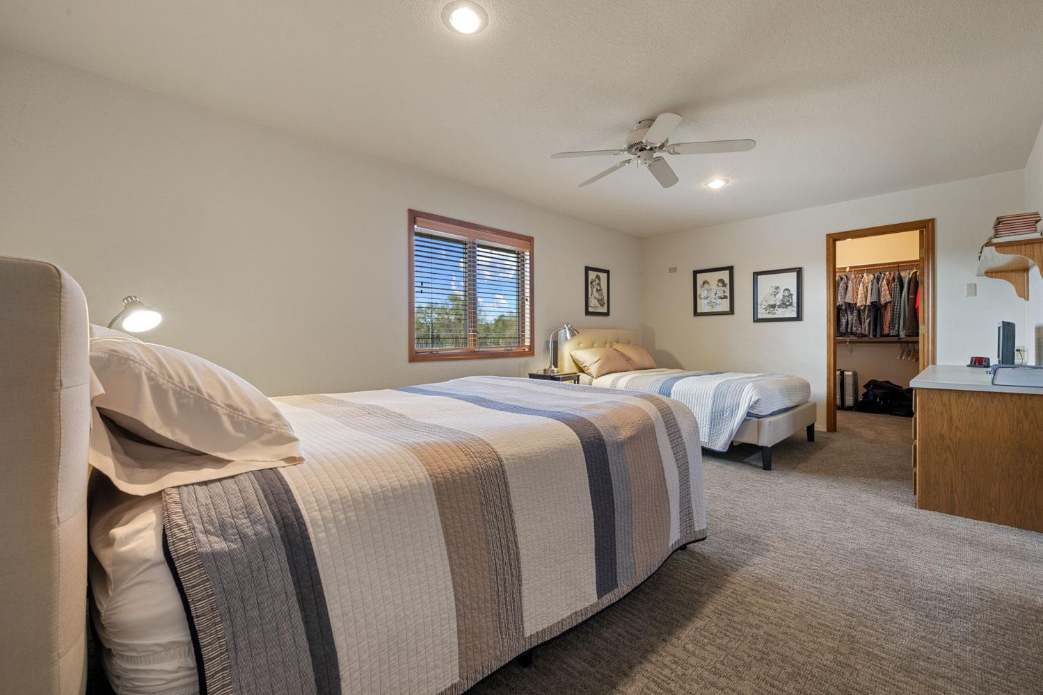 19909 Comstock Road Linden, CA 95236 - Photo 19 of 51 a bedroom with a bed and a chandelier