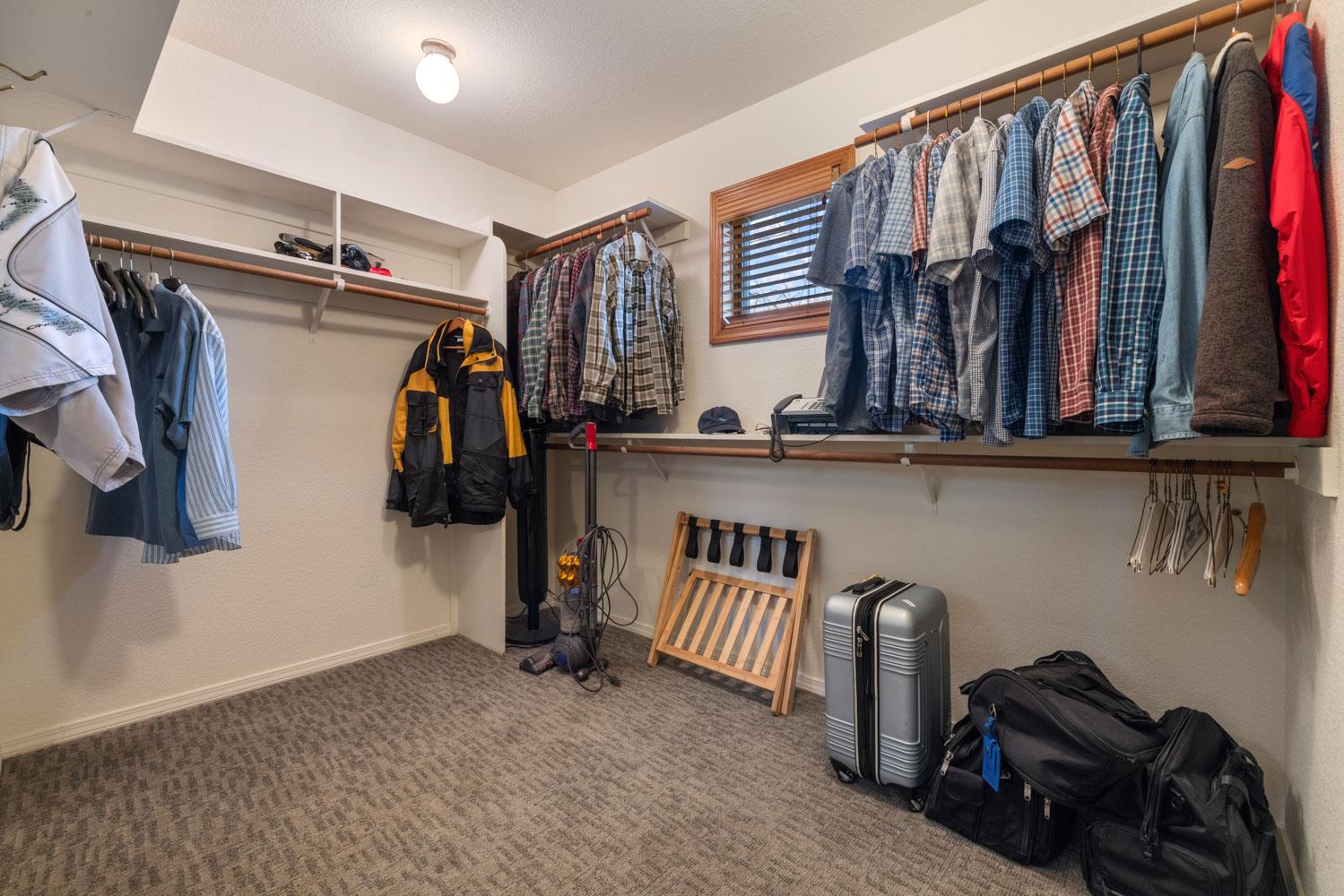 19909 Comstock Road Linden, CA 95236 - Photo 20 of 51 a view of walk in closet with clothes and shoes