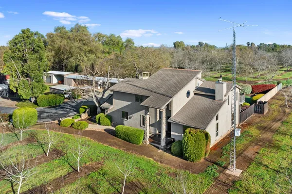 an aerial view of a house with a big yard