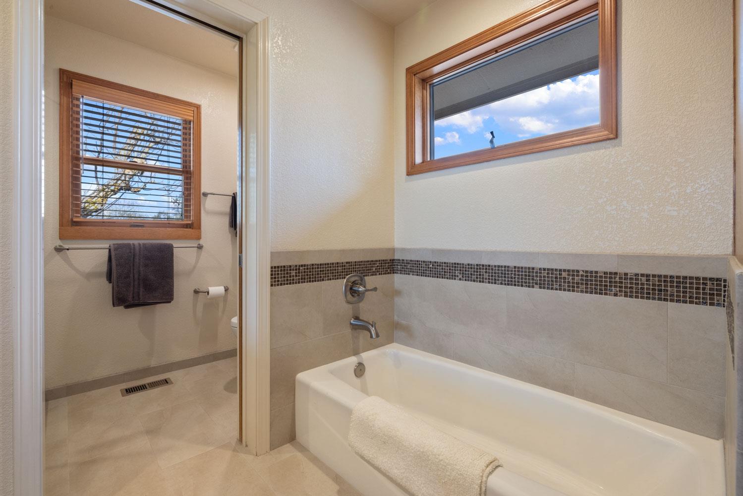 19909 Comstock Road Linden, CA 95236 - Photo 23 of 51 a bathroom with a tub and a shower