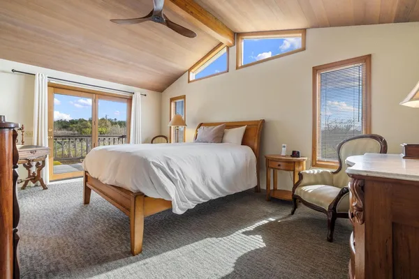 a bedroom with a bed chair and window