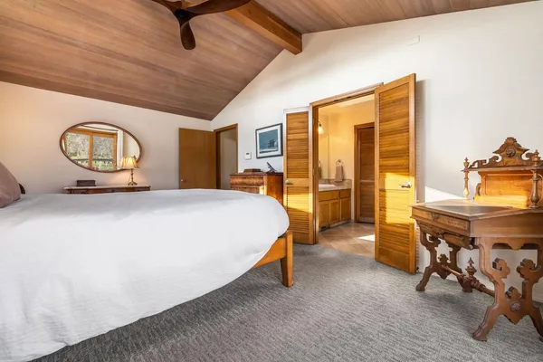 a bedroom with a bed a table and chair