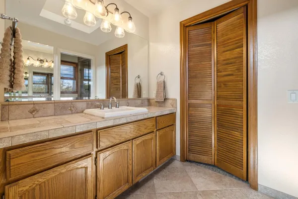 a bathroom with a sink a vanity and a mirror