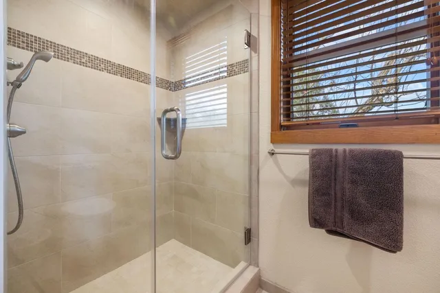 a bathroom with a shower and a window