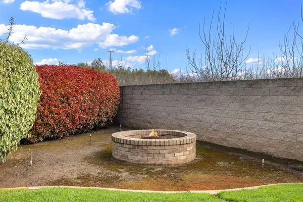 a swimming pool with outdoor seating and yard