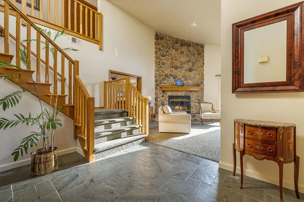 a view of a entryway door of the house and living room