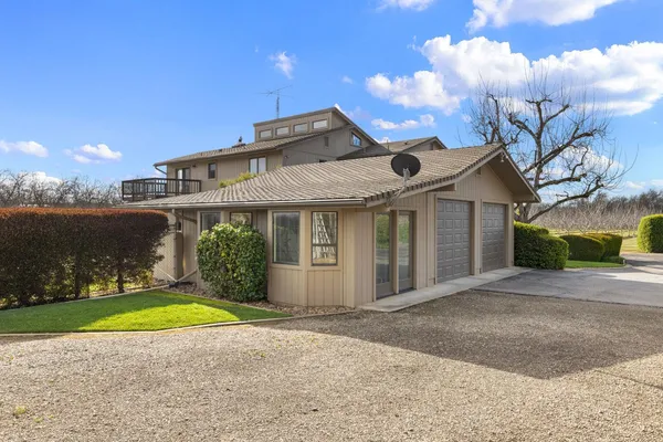 a view of a street with a bench and trees