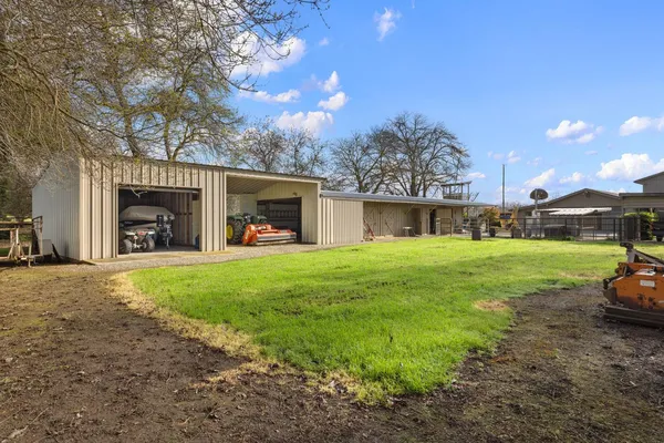 an aerial view of a house with a yard and outdoor seating