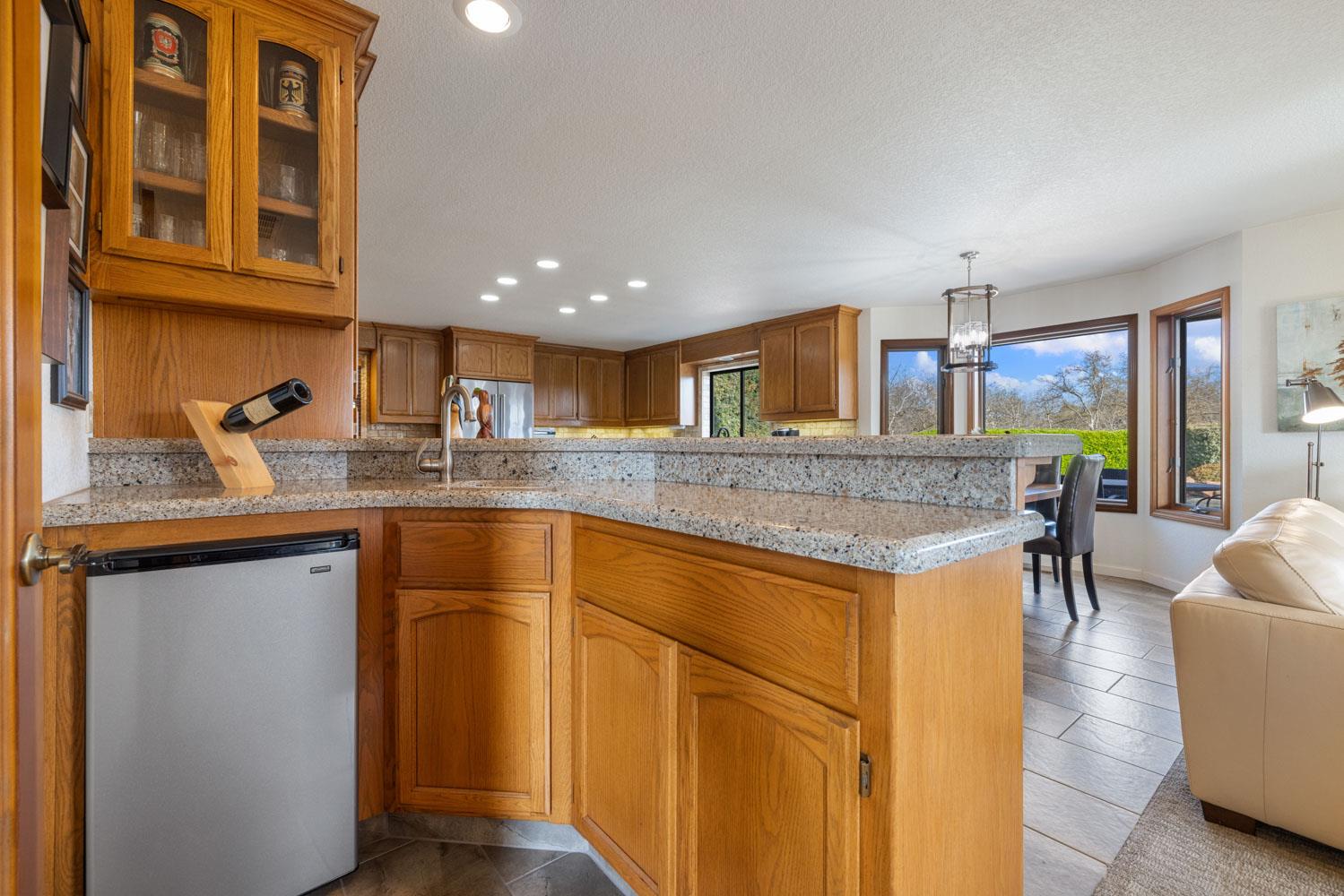 19909 Comstock Road Linden, CA 95236 - Photo 7 of 51 a kitchen with stainless steel appliances granite countertop a sink and a refrigerator