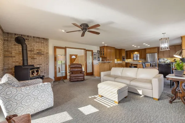 a living room with furniture and a view of kitchen