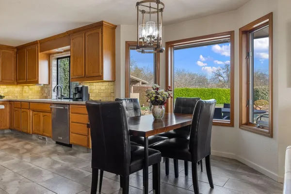 a dining room with furniture a chandelier and window