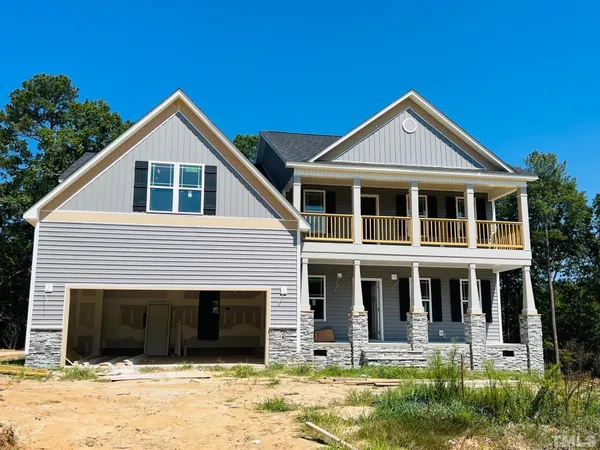 a front view of a house with yard and garage