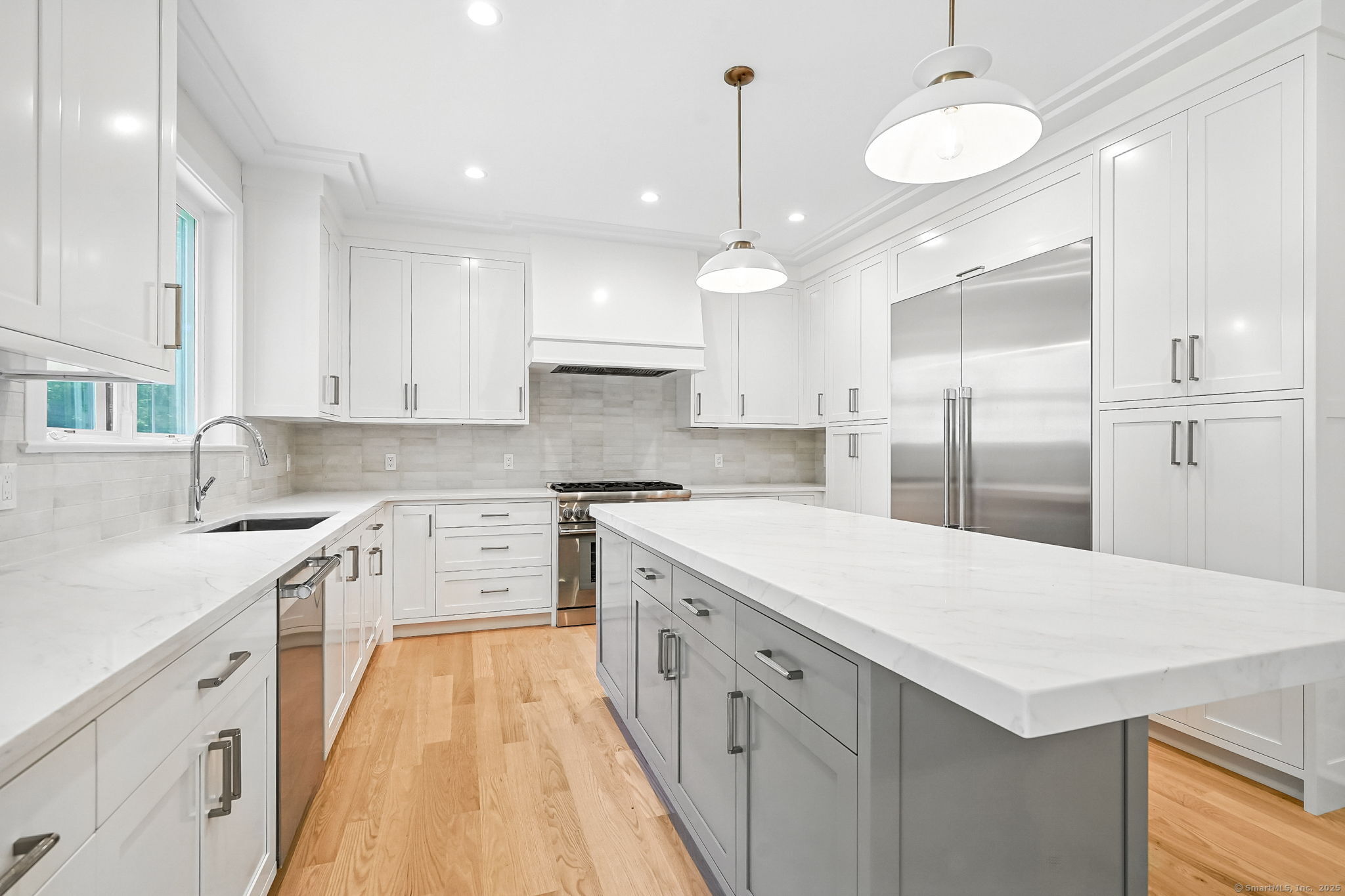 28 Pin Oak Court Westport, CT 06880 - Photo 1 of 1 a kitchen with a sink a center island cabinets and a window