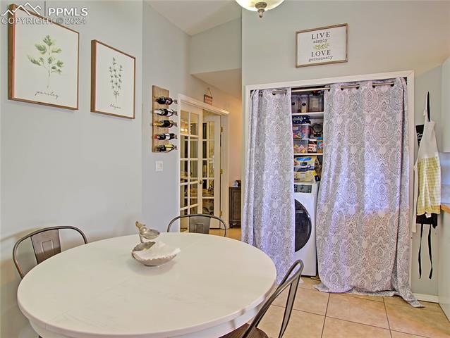 6335 Bismark Road Colorado Springs, CO 80922 - Photo 5 of 21 Tiled dining space with washer / clothes dryer