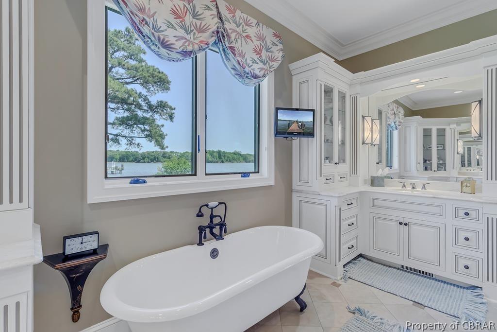 2055 Ditchley Road Kilmarnock, VA 22482 - Photo 29 of 48 Bathroom featuring tile flooring, ornamental molding, a bath to relax in, and vanity