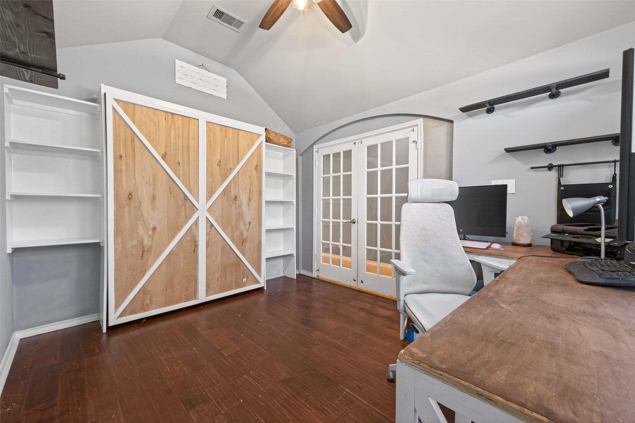 27443 Rebecca Field Lane Spring, TX 77386 - Photo 6 of 31 This photo featuring a built in Murphy Bed, built-in shelves for added guest space in your home office.