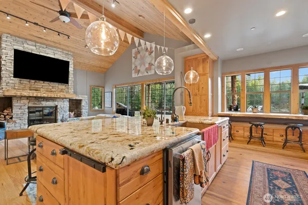 a kitchen with a table chairs sink and cabinets