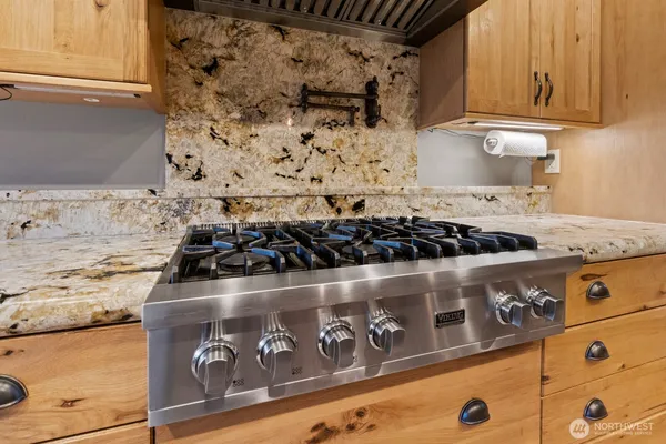 a kitchen with stainless steel appliances granite countertop a stove and a sink