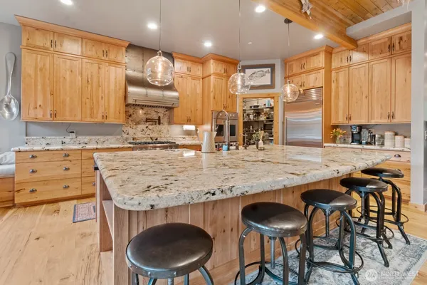 a dining room with furniture and large windows