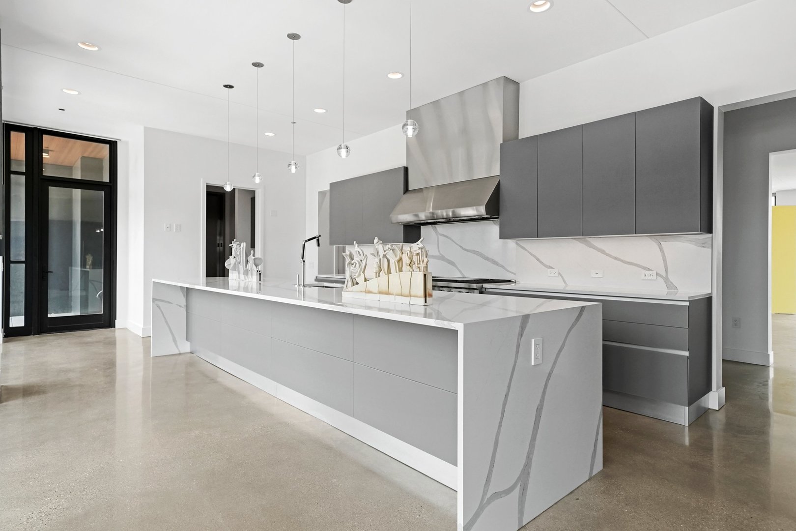 900 West Washington Boulevard, Unit 901 Chicago, IL 60607 - Photo 5 of 20 a kitchen with stainless steel appliances kitchen island granite countertop a refrigerator and a sink