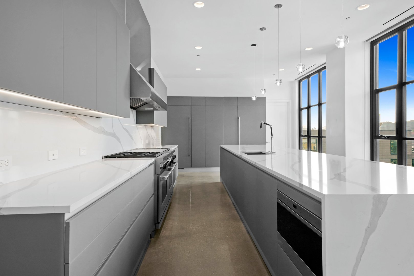 900 West Washington Boulevard, Unit 901 Chicago, IL 60607 - Photo 7 of 20 a large kitchen with stainless steel appliances a sink and a stove