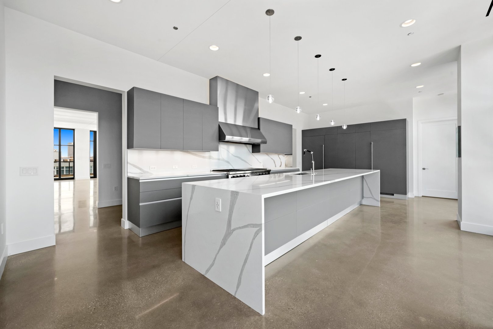 900 West Washington Boulevard, Unit 901 Chicago, IL 60607 - Photo 8 of 20 a large white kitchen with stainless steel appliances a white stove top oven and a refrigerator