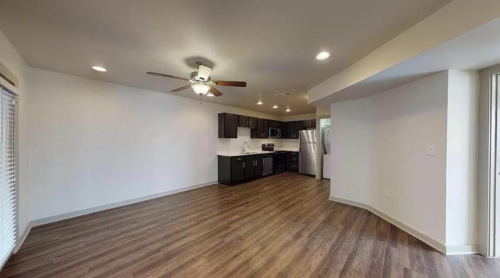 1925 Moser Avenue, Unit S1 Dallas, TX 75206 - Photo 1 of 21 a view of a kitchen with a sink a ceiling fan and wooden floor