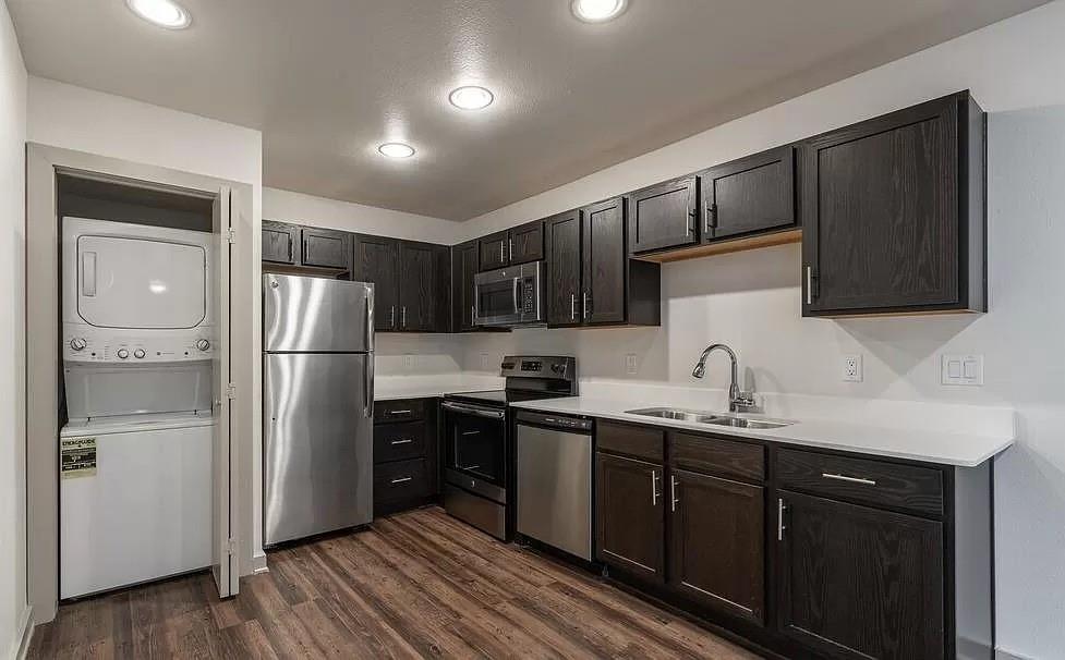 1925 Moser Avenue, Unit S1 Dallas, TX 75206 - Photo 3 of 21 a kitchen with stainless steel appliances granite countertop a refrigerator sink and wooden cabinets
