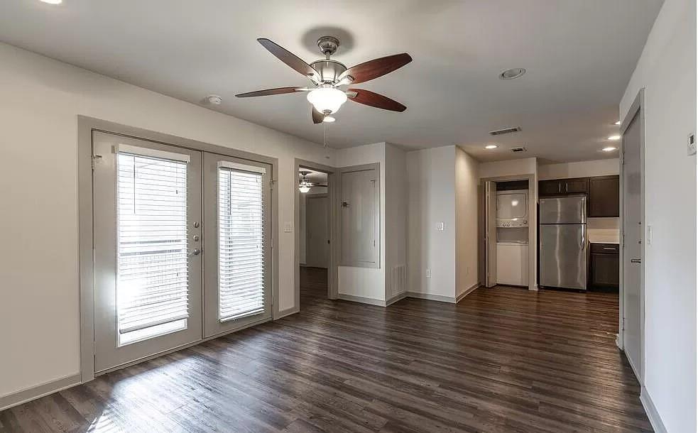 1925 Moser Avenue, Unit S1 Dallas, TX 75206 - Photo 8 of 21 a view of an empty room with wooden floor and a window