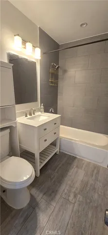 a bathroom with a sink mirror vanity and toilet