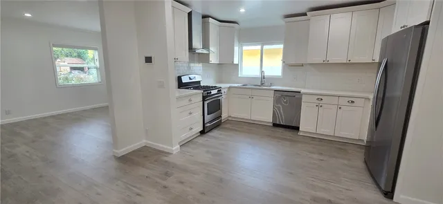 a kitchen with white cabinets and white appliances