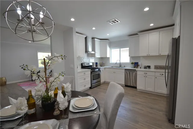 a kitchen with white cabinets and appliances
