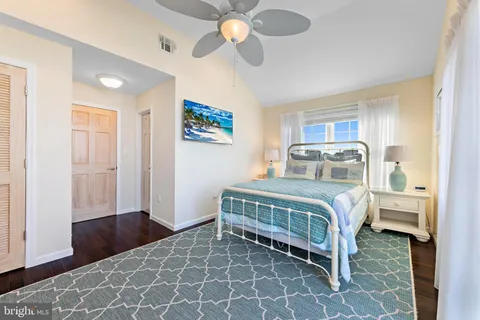 a bathroom with a granite countertop toilet sink and mirror
