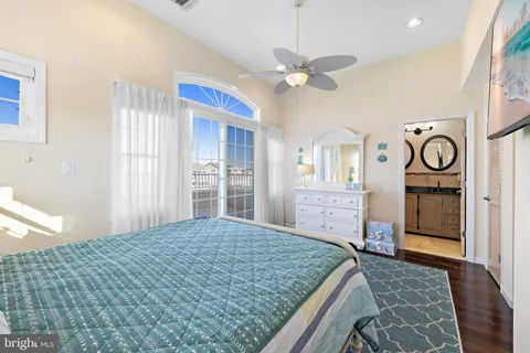 a bathroom with a granite countertop sink a toilet and a mirror