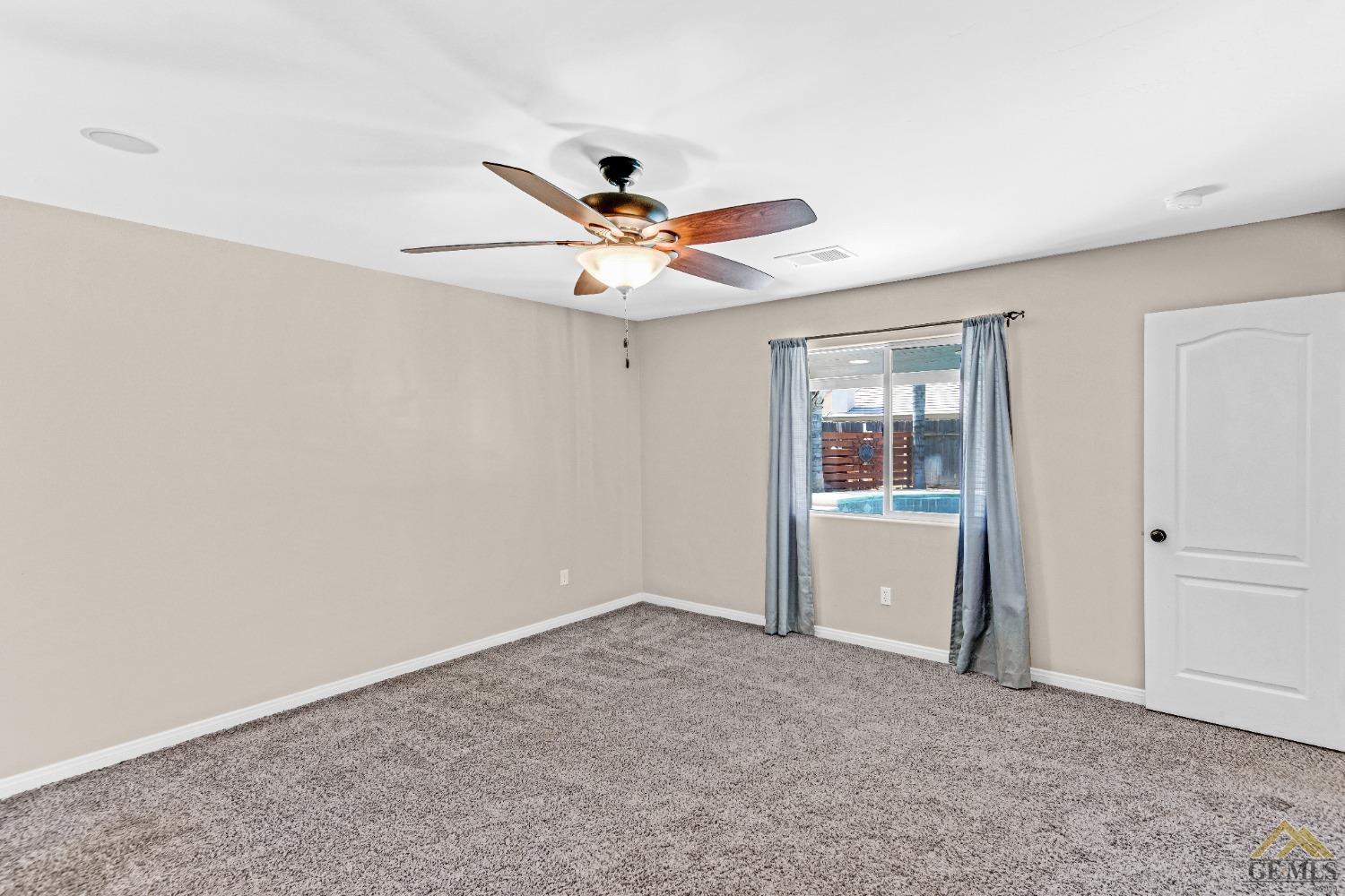 Undisclosed Address Bakersfield, CA 93312 - Photo 14 of 31 wooden floor in an empty room with a window